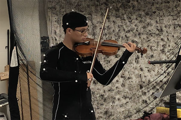 A Miami University student plays the violin 
