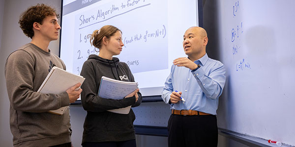 Liran Ma, right, Naus Family Faculty Scholar Professor and chair of Computer Science and Software Engineering, talks with Miami University students
