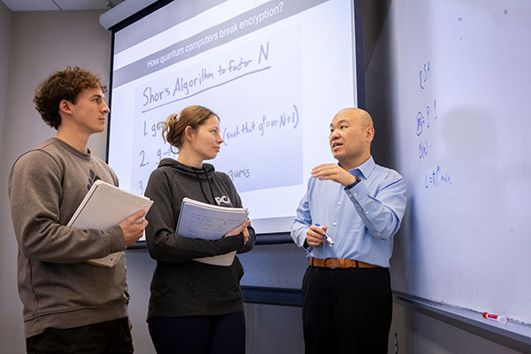 Liran Ma, right, Naus Family Faculty Scholar Professor and chair of Computer Science and Software Engineering, talks with Miami University students