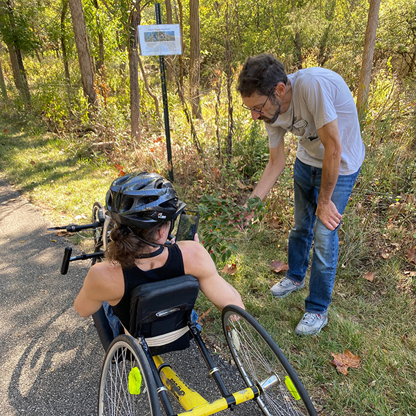 Dave Gorchov, professor of Biology and chair of the Miami University Natural Areas committee, talks to handcyclist Bart Burgess about deer browse (photo by Margo Rutledge Kissell).