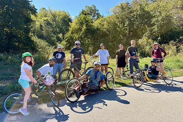 Several people took part in the first Adaptive Nature Walk on Wheels organized by Yoshi Tomoyasu, associate professor of Biology at Miami University (front center). The field trip took place on paved trails through scenic autumn woods on the city’s Oxford Area Trails (OATS) that meander through the Miami University Natural Areas (photo by Chie Tomoyasu).
