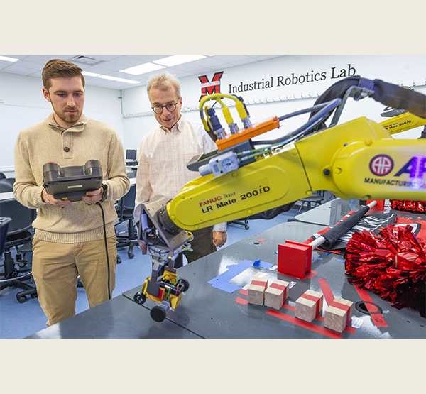 Dave Hartup works with Electrical and Computer Engineering graduate student Bradley Gartner in the Industrial Robotics Lab at Miami University College of Engineering and Computing (CEC).