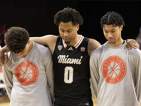 Three Miami men's basketball players stand quietly before the Love.Honor.Care game (photo by Scott Kissell).